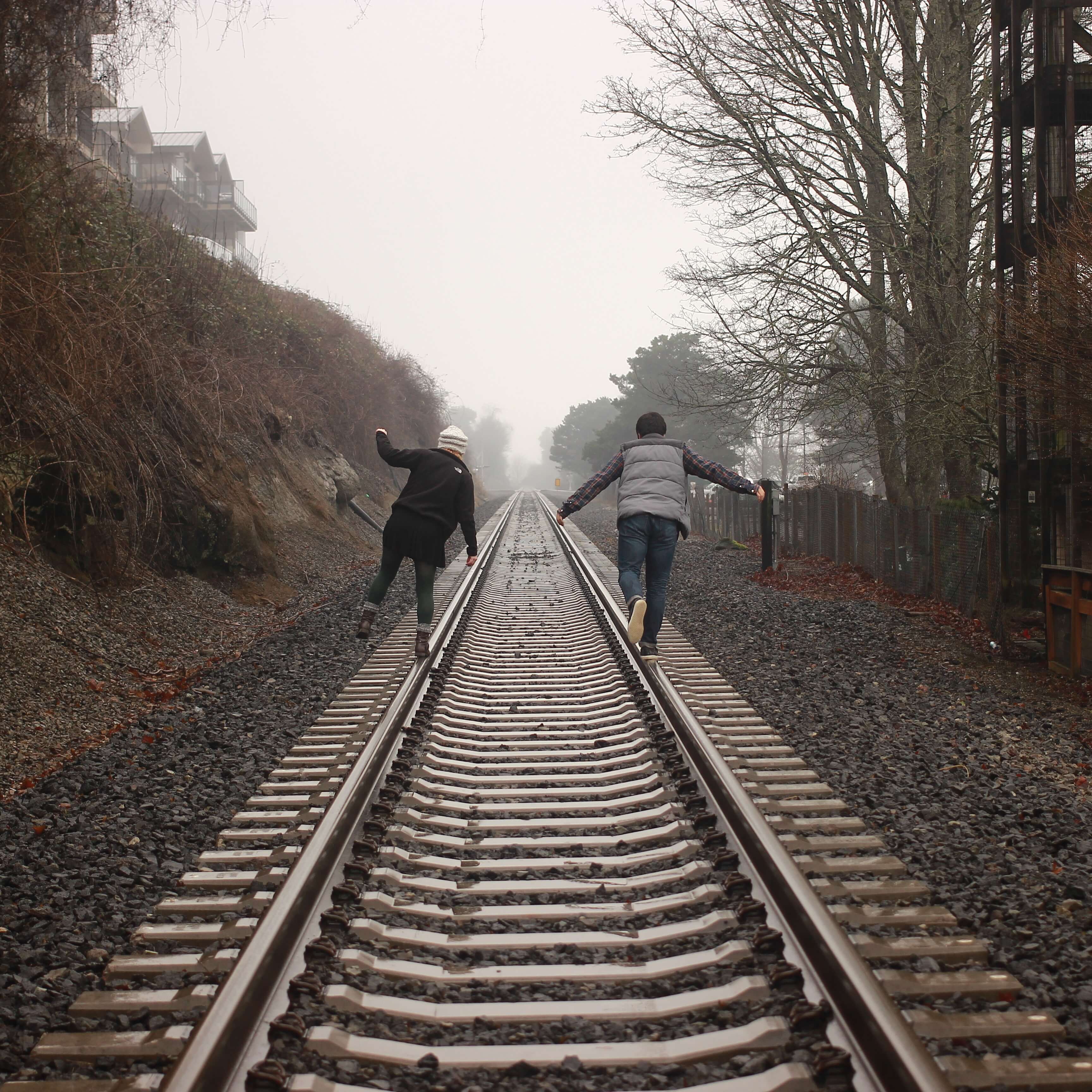 picture of two girls walking down train tracks