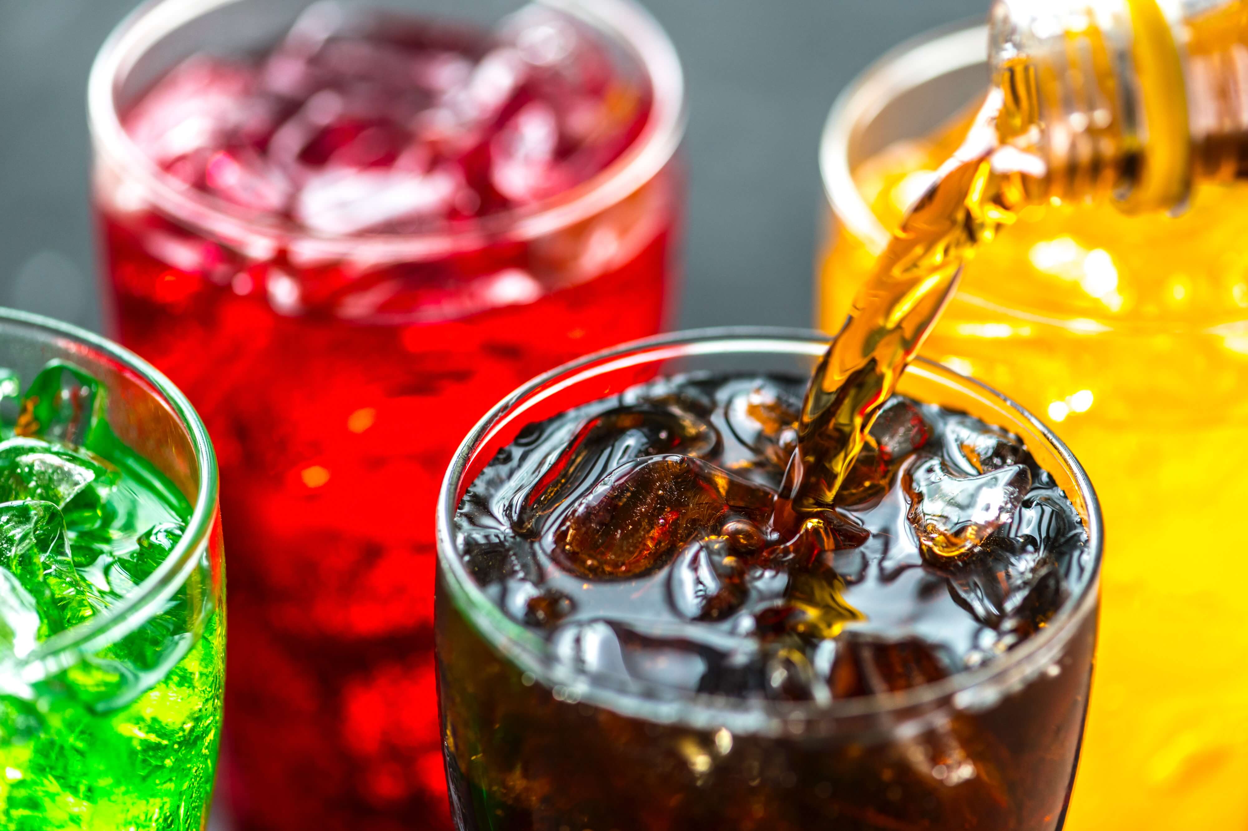 picture of 3 glasses of soda being poured