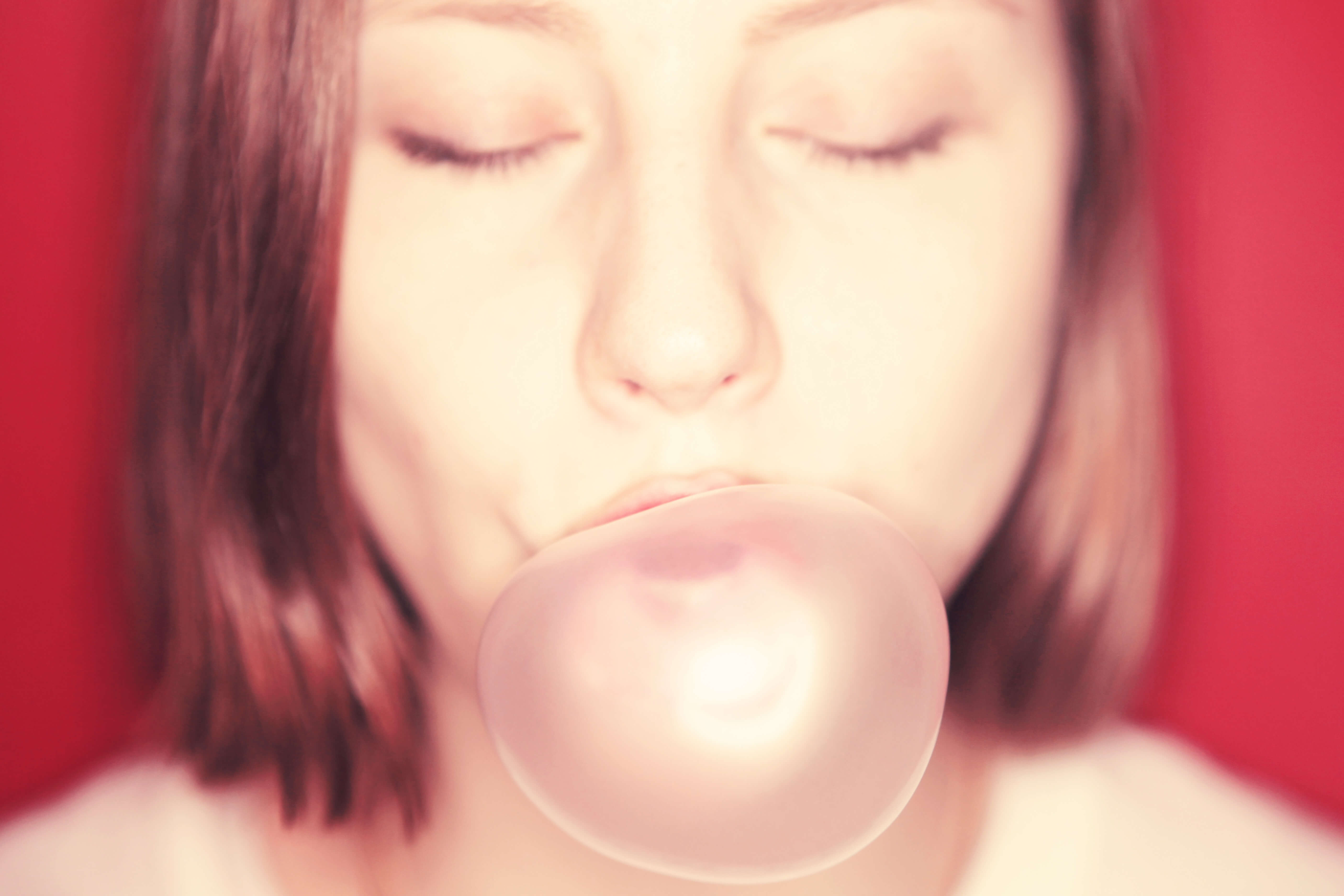 picture of a girl blowing a bubble with gum