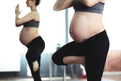 Picture of a Pregnant women looking at her belly